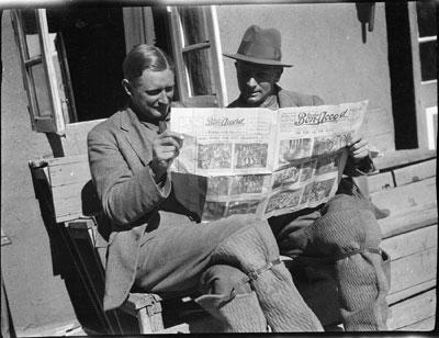 Lt Sangster and Capt Mulligan reading newspaper