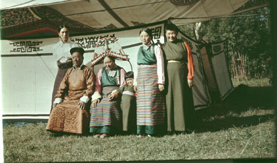 Taring family members in front of applique tent
