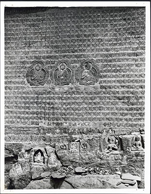 Buddha images carved into rock face