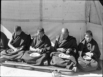 Four monks eating