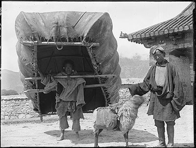 Man carrying hide boat