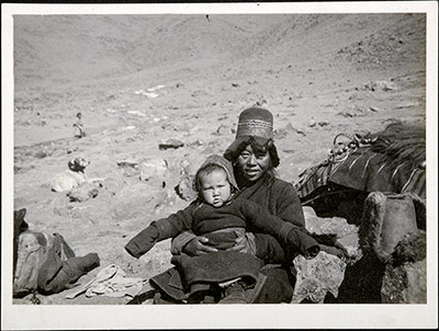 Woman with a child on her lap resting during a journey