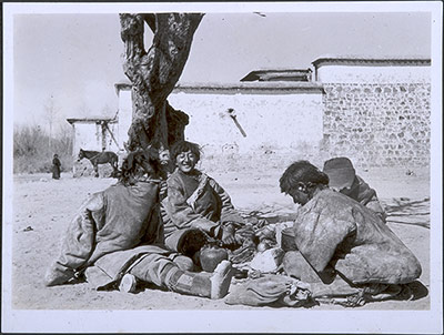 Men in leather fleece-lined coats preparing a meal