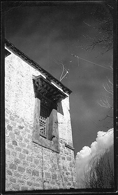 Window of a house with electrical wire above it