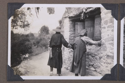 Pilgrims by prayer wheels on the Lingkhor, Lhasa