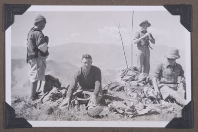 Mission staff having a picnic in the hills above Lhasa
