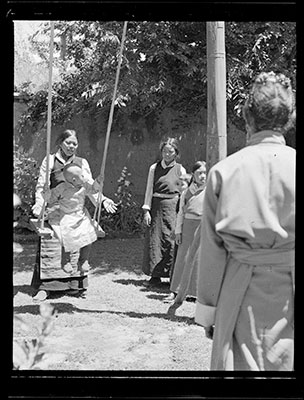 Ngari Rinpoche on a swing in the Dekyi Lingka garden