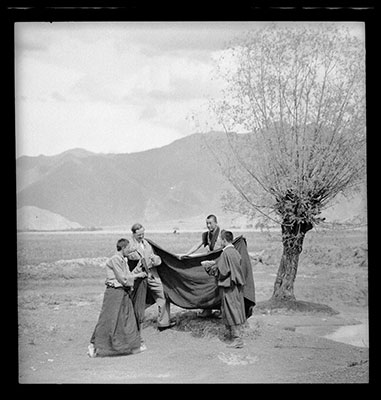 James Guthrie being dressed in a monk's shawl