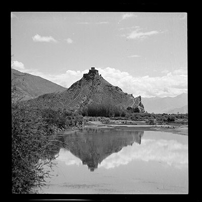 Chakpori reflected in the waters of the Kyichu river