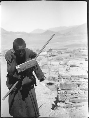 Monk seeking alms in Gyantse