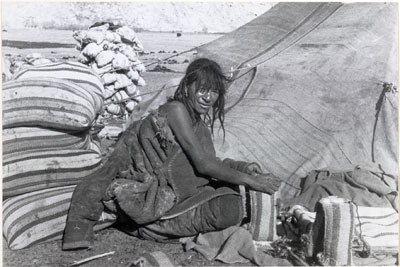 Nomad sewing up bags of salt