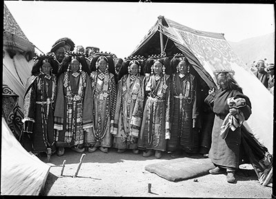 'Four ladies, gorgeously dressed in coloured silks and head-dresses of turquoise and coral'. The Ya-sos' four Maids of Honour with two assistants