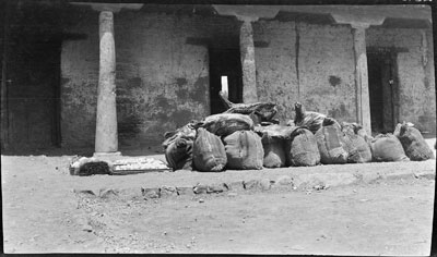 Presents of food from Tibetan Government to author. Butter, eggs, and bags of barley-flour, peas, and rice. On the top dried carcases of sheep