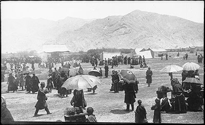 Tents and spectators at 'The Gallop behind the Fort'. Cakes for sale under umbrellas in right and centre foreground
