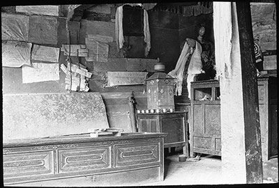 Court room with prayer wheel (right centre), chests, and records fastened to the walls