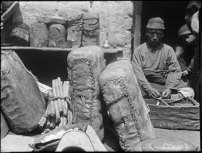 Tea shop in Lhasa. Tea bricks on shelf. Sacks, containing bricks, below
