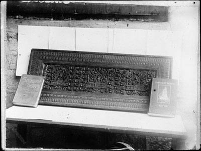 A Tibetan book-cover in richly carved wood