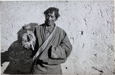 A nomad turning a prayer-wheel