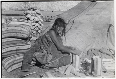 Nomad sewing up bags of salt