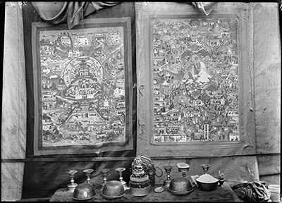 Two Thanka behind altar with offering bowls