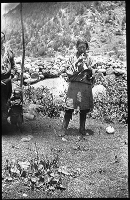 Man playing a gyaling or Tibetan clarinet