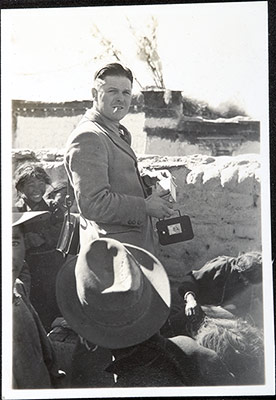 Harry Staunton holding a cine camera on roof in Gyantse
