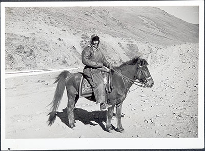 Hugh Richardson in Tibetan clothes mounted on a horse