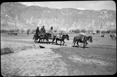 A family travelling along a road outside Lhasa