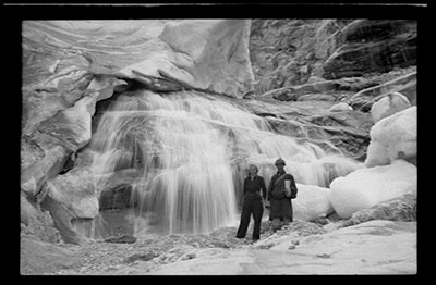 Travellers in front of a frozen waterfall near Melong