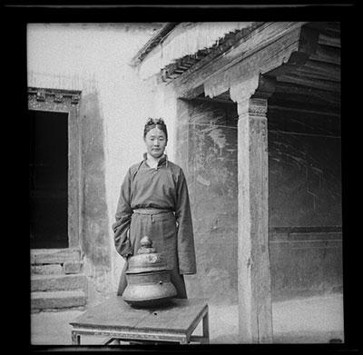 Phunkhang standing behind a bronze vessel on a table