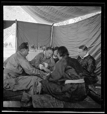 Men playing a game under a tent
