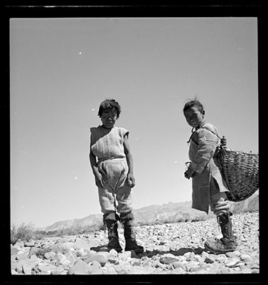 Two village boys standing on rocky ground