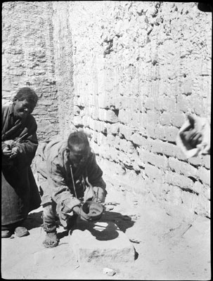 Two Tibetans, receiving alms