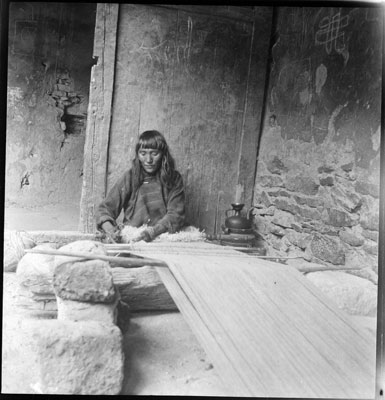 Woman weaving woollen blanket