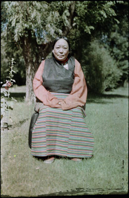 Lhalu Lhacham seated on a chair in a garden
