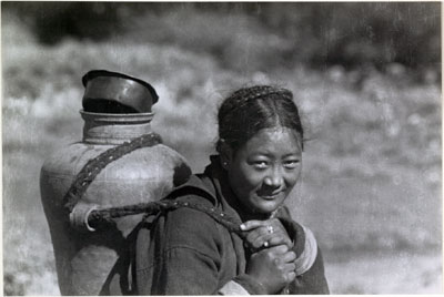 Tibetan woman carrying water jug